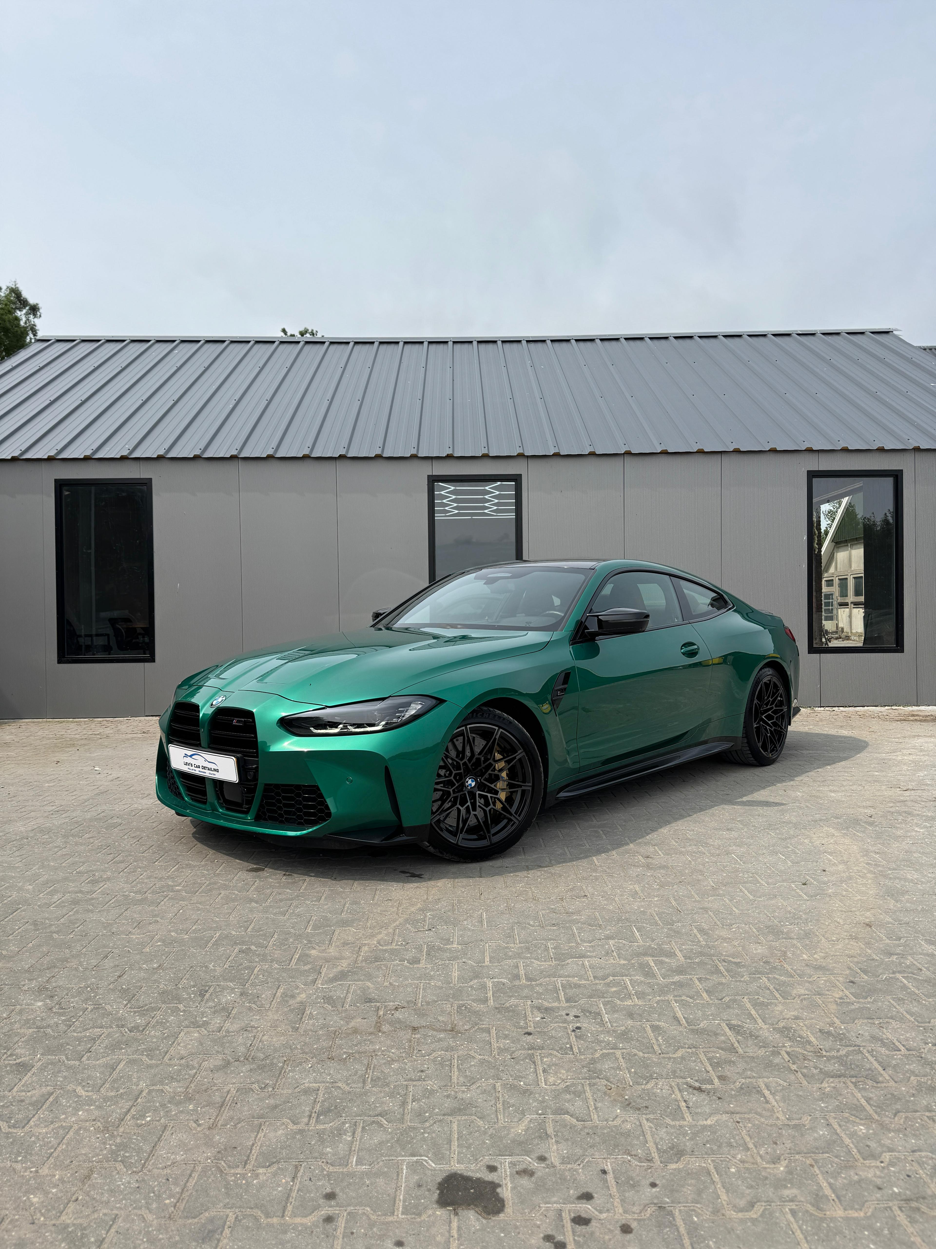 BMW M4 Competition green side view